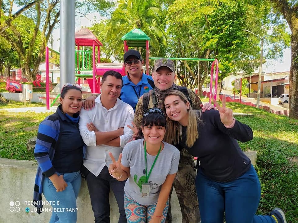 Adam with local friends in a town park, Colombia, March 2021